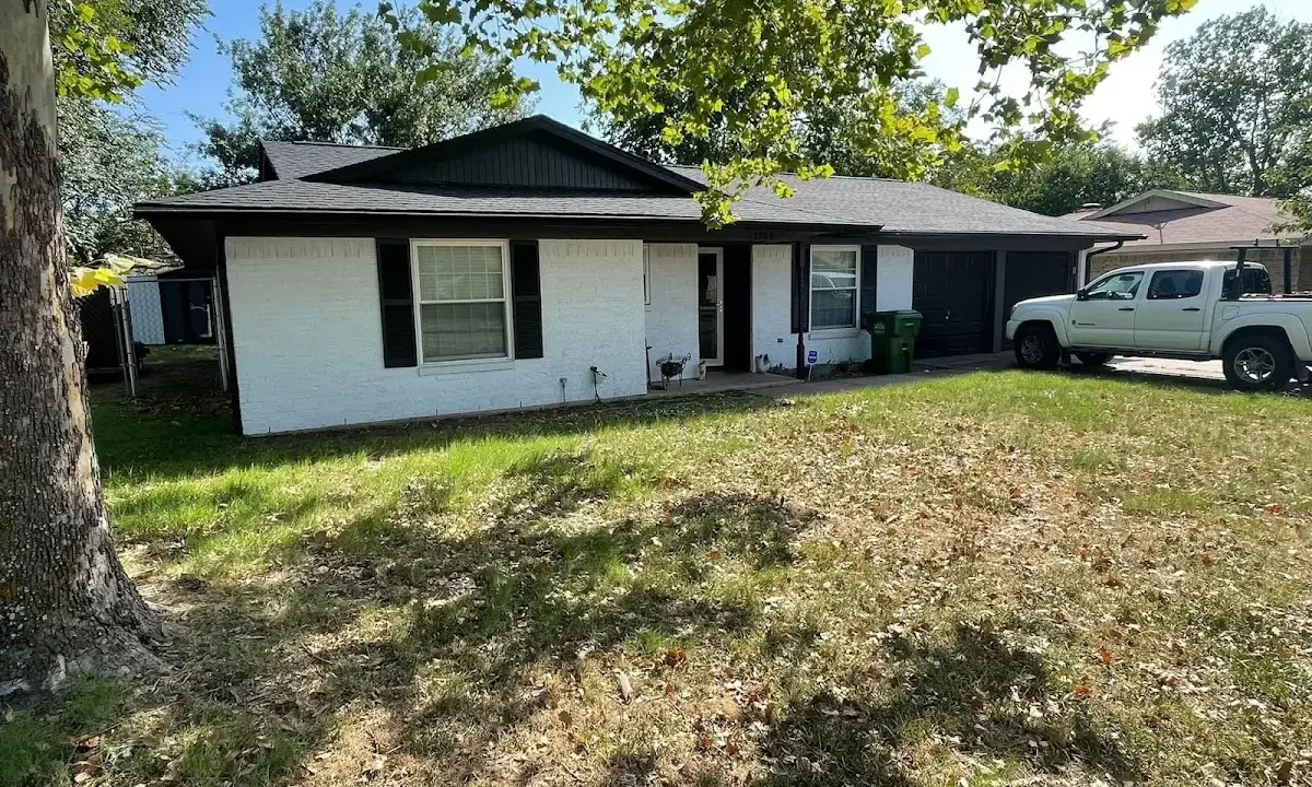 Professional roofing crew working on a residential roof in Seaside